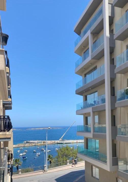 a view of the ocean from a building at Side Seaview St Pauls Bay Apartment in St. Paul's Bay