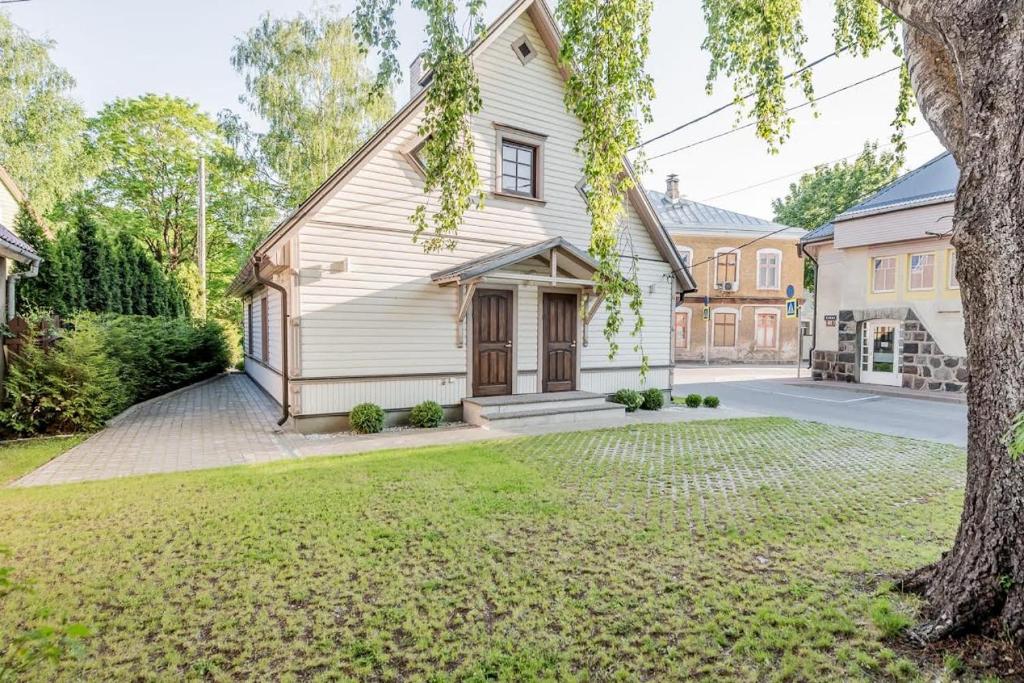a large white house with a yard at Vingi Familyhouse with free parking and sauna in Pärnu