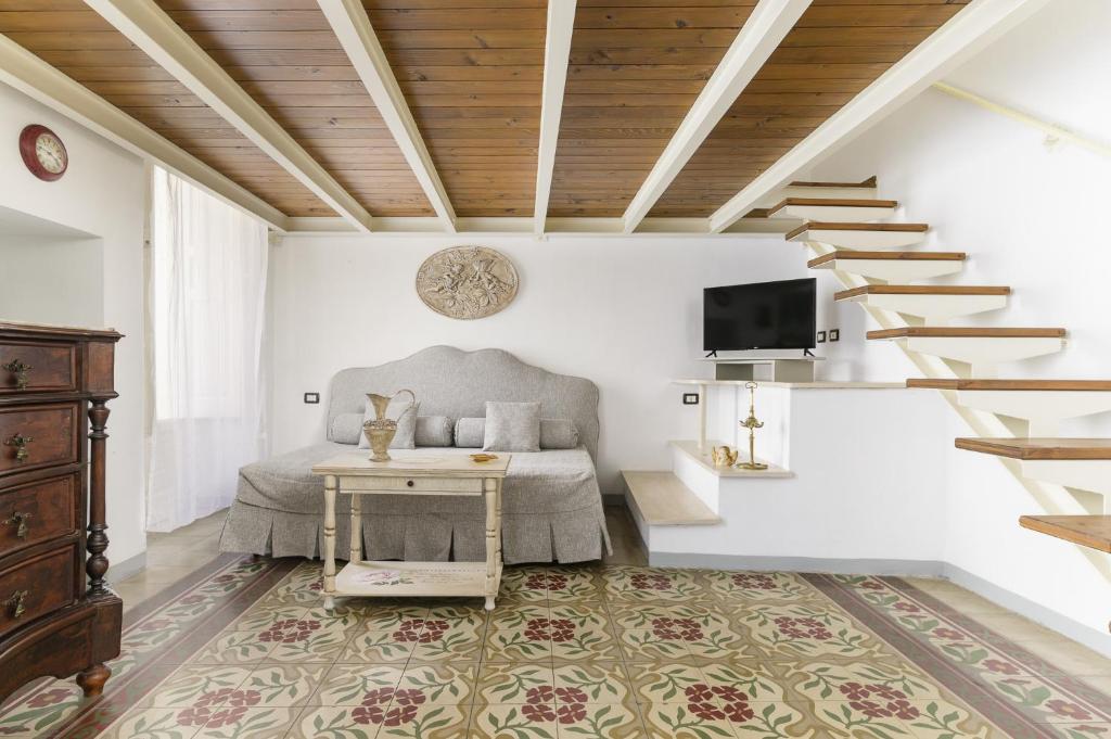 a bedroom with a bed with a table and a staircase at Appartamento Vintage con Balcone by Wonderful Italy in Ostuni