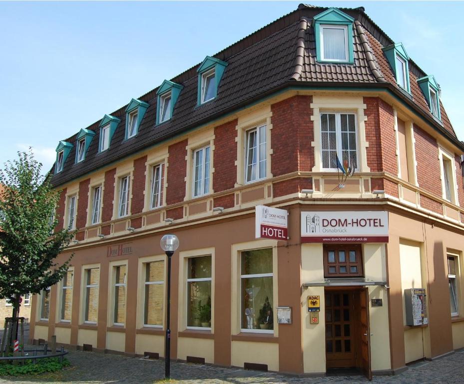 a brown building with a brown roof at Dom Hotel in Osnabrück