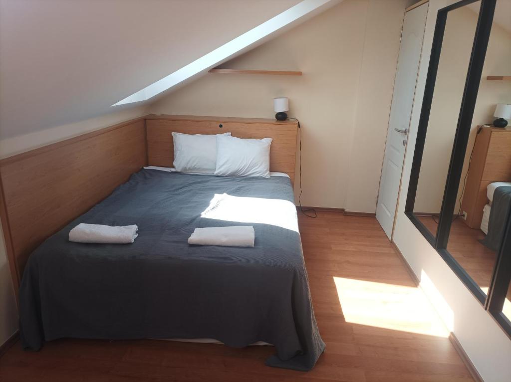 a bedroom with a bed with two towels on it at Central Apartment at Nagymezo street in Budapest