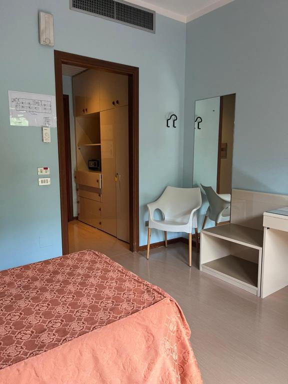 Postel nebo postele na pokoji v ubytování Albergo Casa dell'Ospite