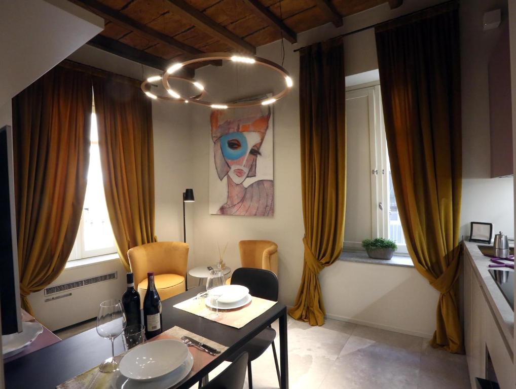 a dining room with a table with chairs and a painting at Casa Mandelli in Alba