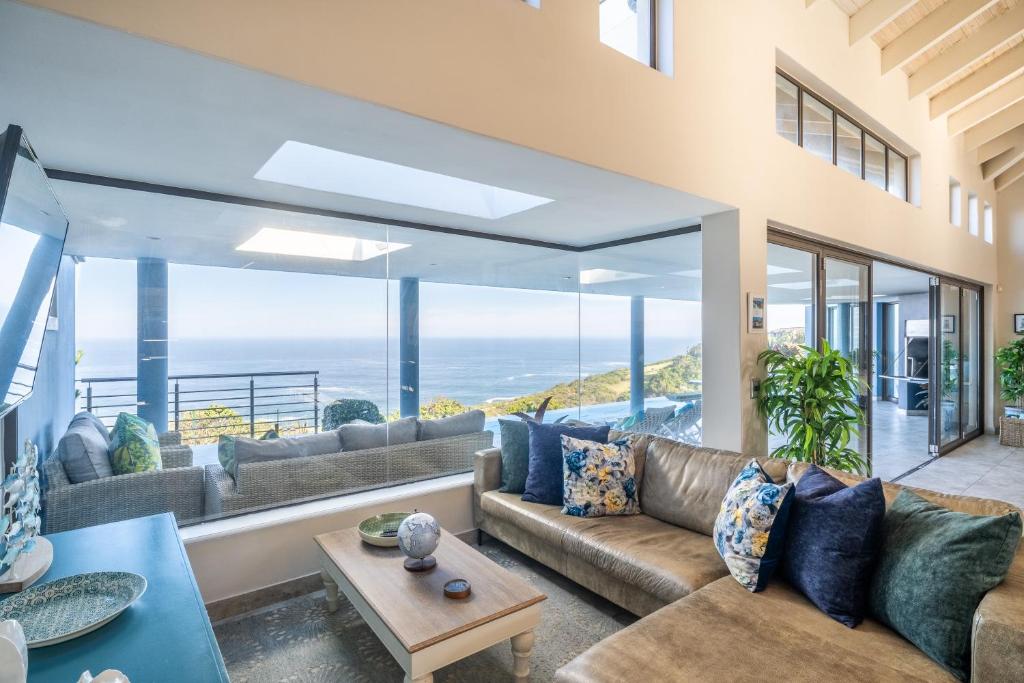 a living room with a couch and a view of the ocean at KNYSNA Breakwaters Haven in Knysna