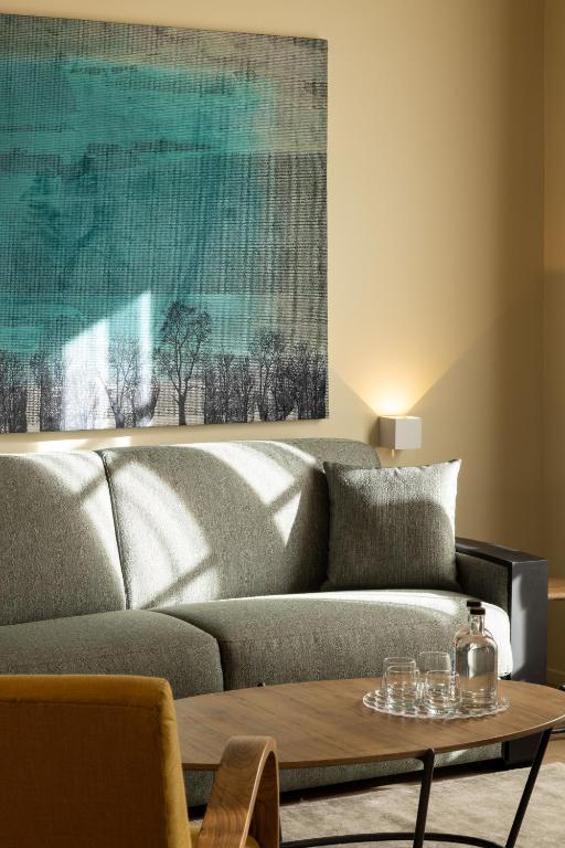 a living room with a couch and a table at Palais Ségurane Boutique Hôtel in Nice