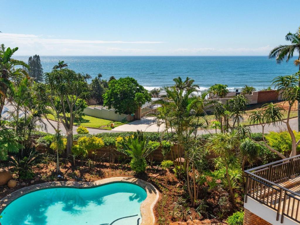 an overhead view of a swimming pool and the ocean at The Hideaway at 88 in Ballito