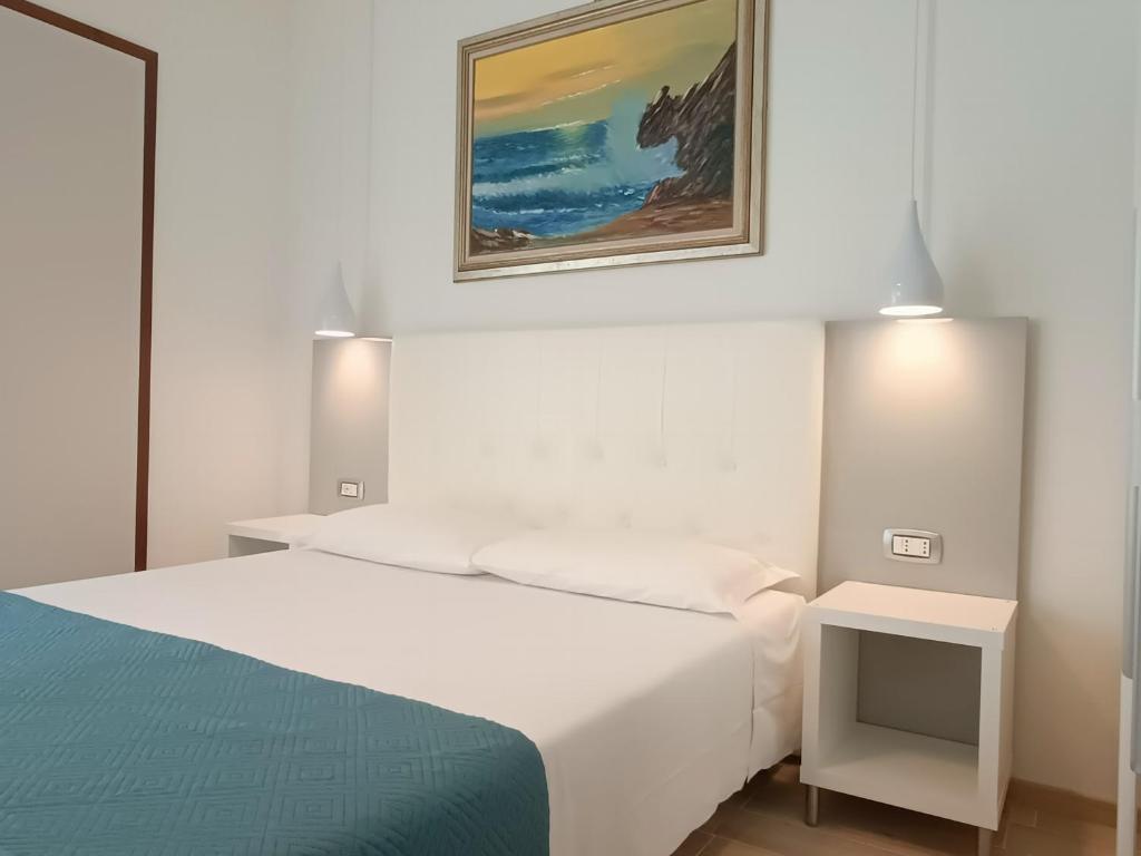 Łóżko lub łóżka w pokoju w obiekcie Hotel Merano