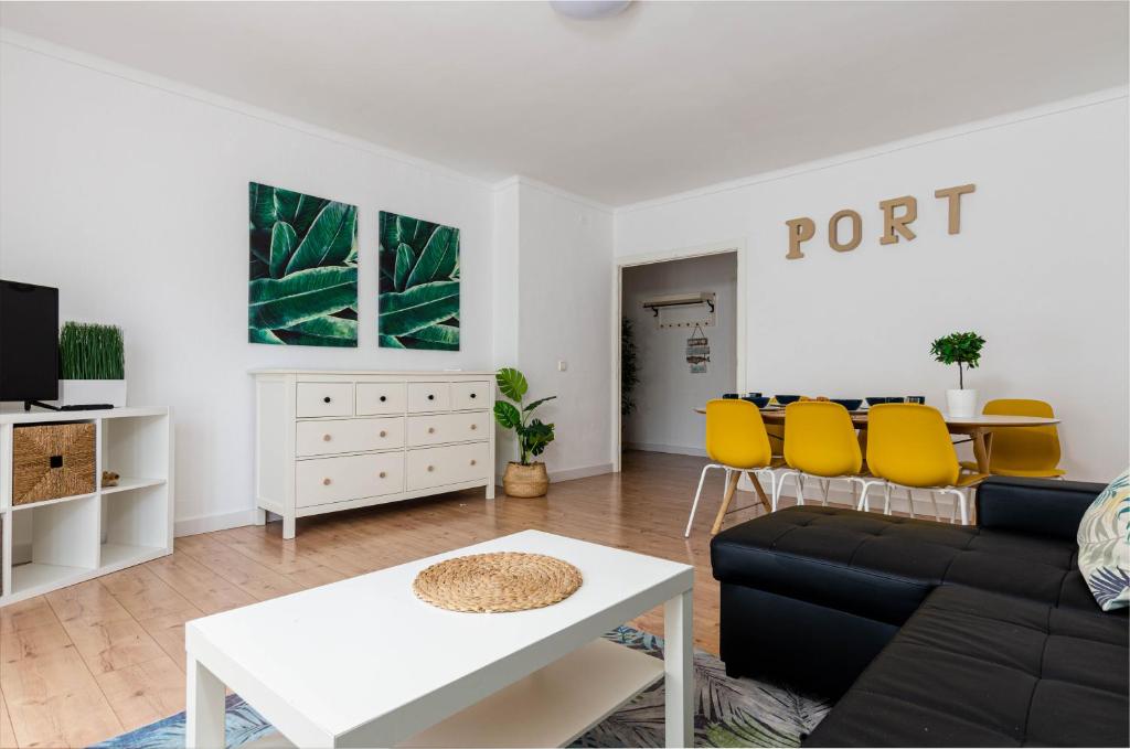 a living room with a couch and a table at Port Apartments in Port d'Alcudia