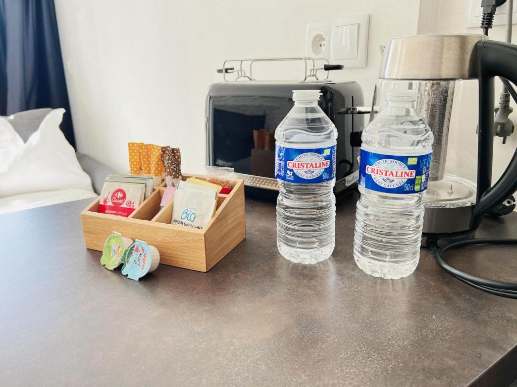 two bottles of water sitting on top of a counter at Domus Via Domitia in Narbonne