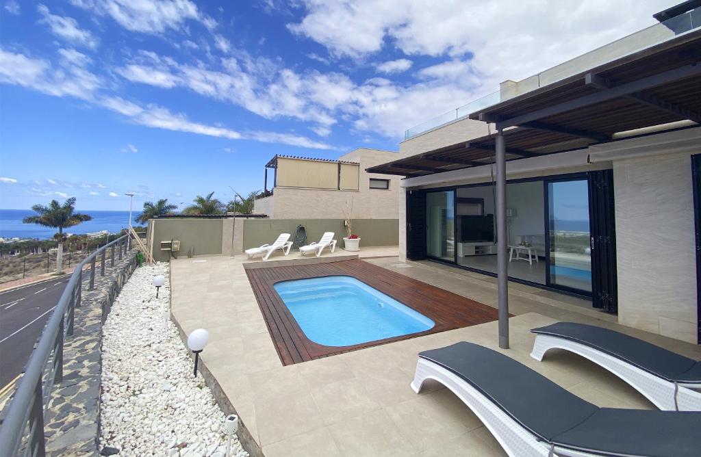 a house with a swimming pool in the backyard at Harmony - Beach & Dream rentals in Playa de las Americas