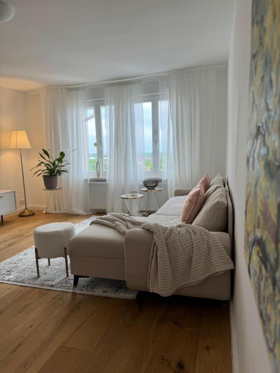 a bedroom with a bed and a couch at Rheinblick-Oase Oppenheim in Oppenheim
