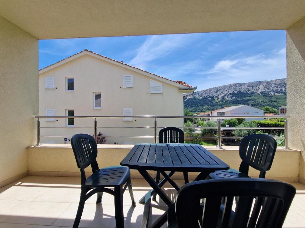 a patio with a table and chairs on a balcony at Wohnung in Baška mit Eigenem Balkon - b59515 in Baška