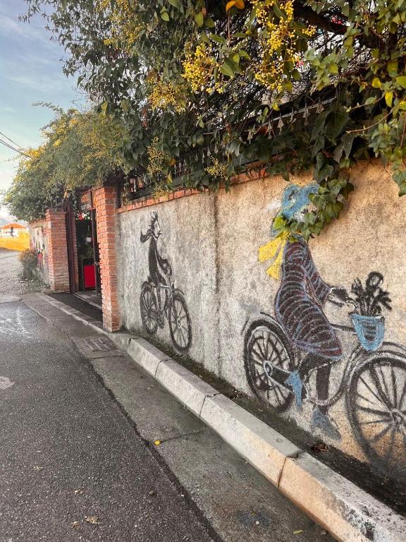 a wall with a painting of a dog on a bike at Divina Hostel in Tirana
