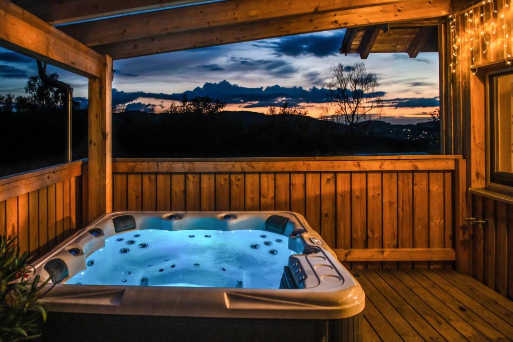 a jacuzzi tub on the deck of a cabin at Chalet Waldzeit in Zachenberg