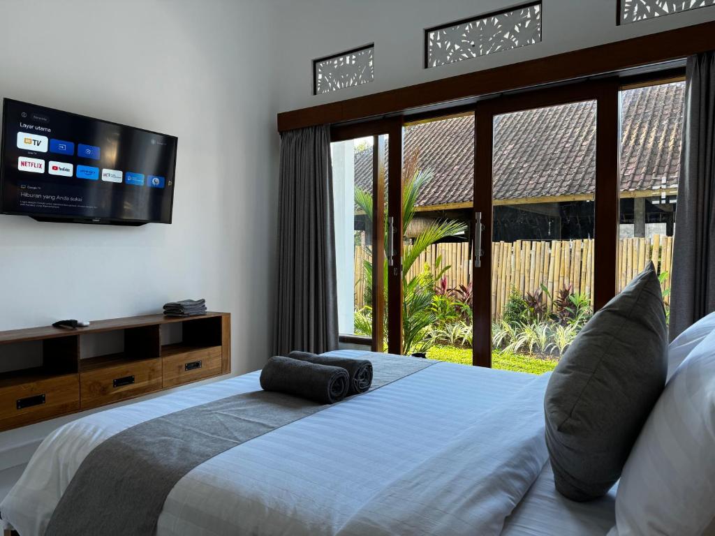 Postel nebo postele na pokoji v ubytování Kokokan House Ubud