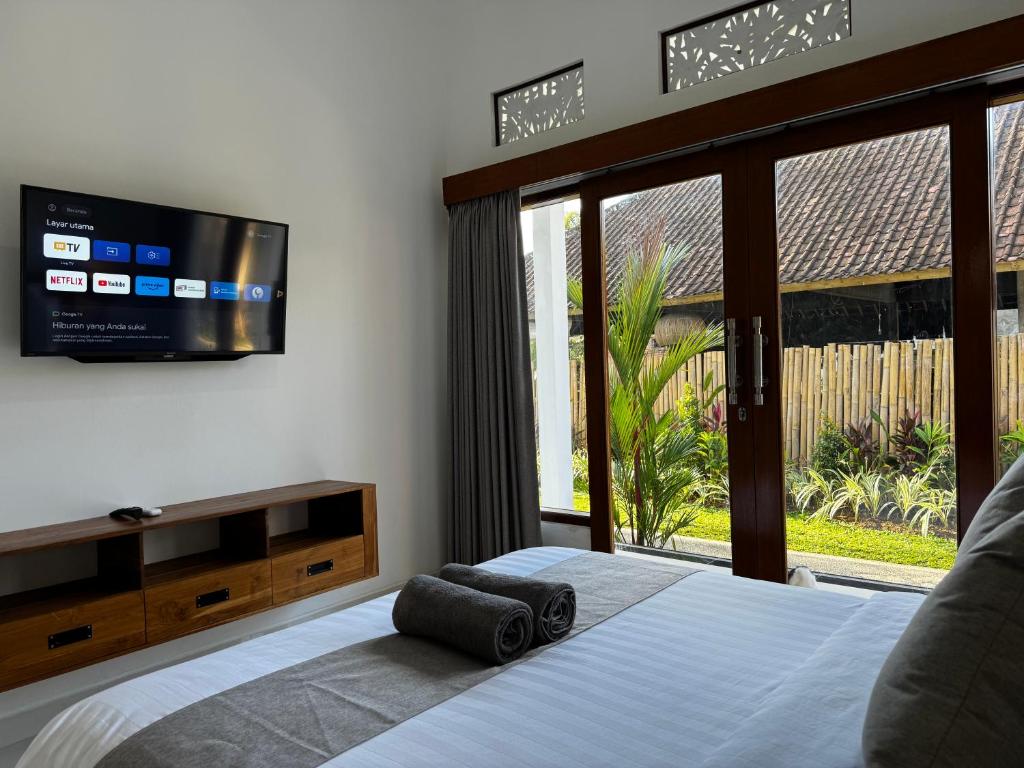 Postel nebo postele na pokoji v ubytování Kokokan House Ubud