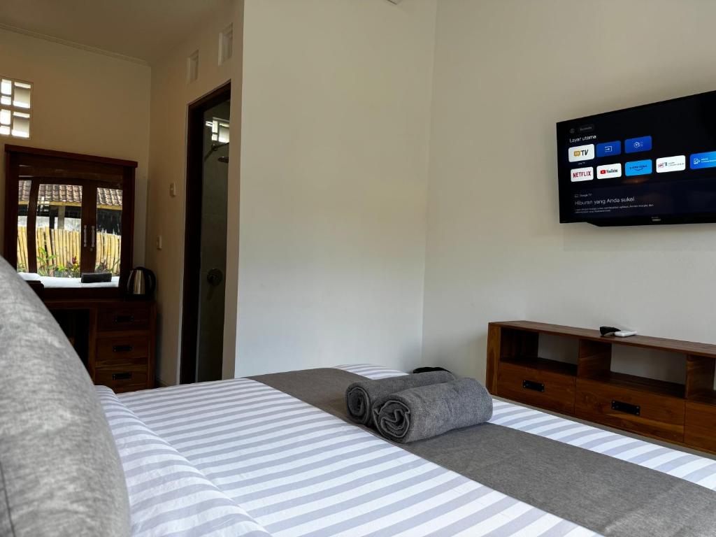 Postel nebo postele na pokoji v ubytování Kokokan House Ubud