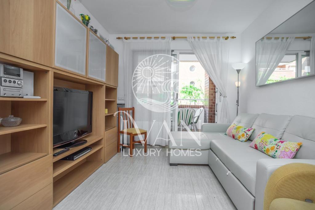 a living room with a white couch and a tv at Casa Arcoiris Ivan Luxury Homes 3ªPlta Norte in Oropesa del Mar