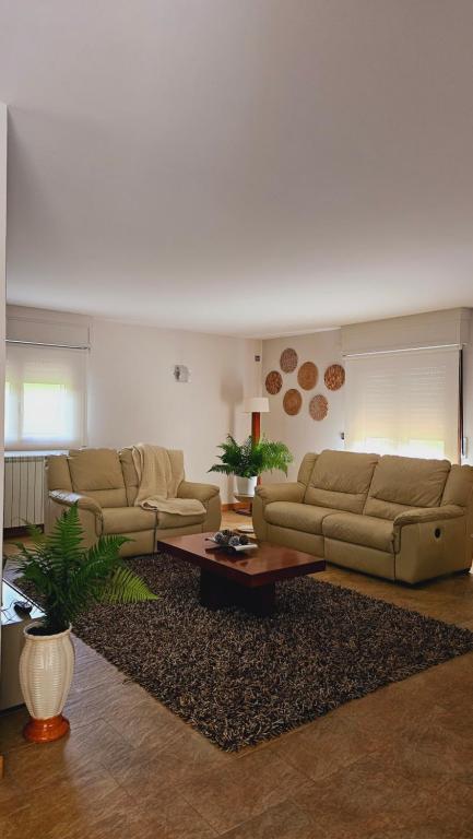 a living room with two couches and a coffee table at Casa Rural Simonan Borda in Oiartzun