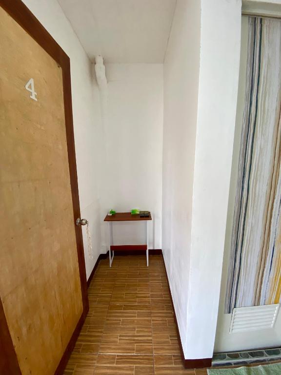 an empty hallway with a table and a door at Moalboal Panagsama beach TopBudz Hostel in Moalboal