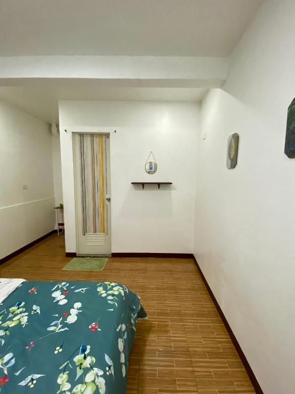 an empty room with a bed and a door at Moalboal Panagsama beach TopBudz Hostel in Moalboal