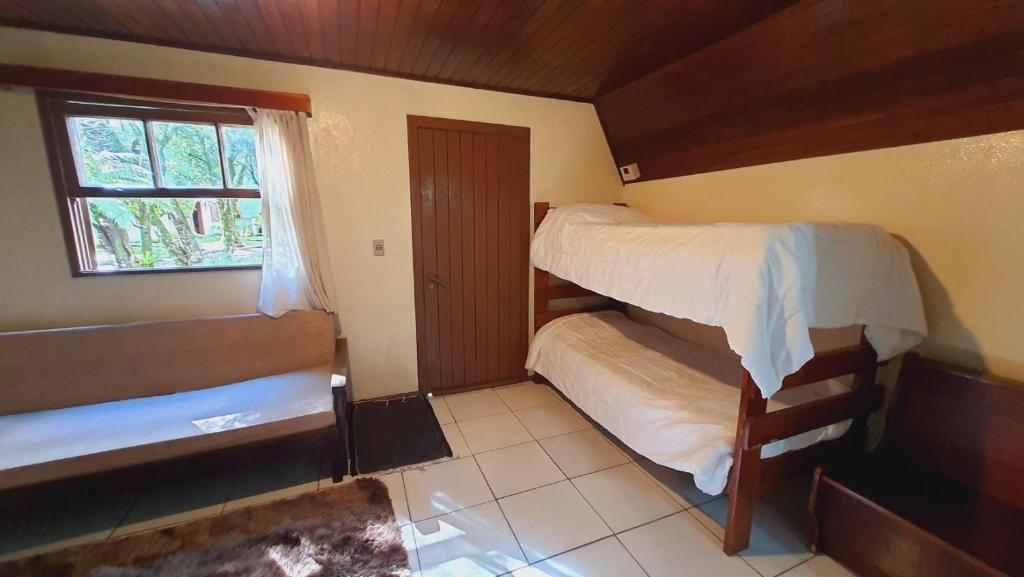 Postel nebo postele na pokoji v ubytování Villa Chalés Gramado - OH HOTÉIS