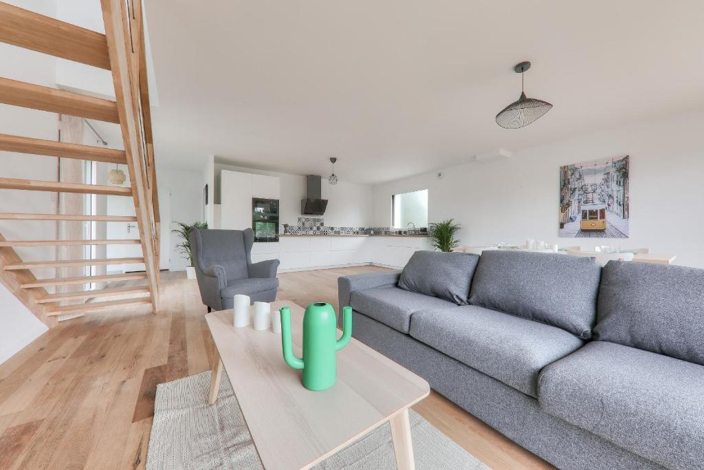 a living room with a couch and a table at Maison pour 8 - 300m de la plage du Rouvran in Le Tour-du-Parc