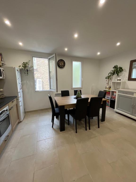 une cuisine et une salle à manger avec une table et des chaises dans l'établissement Charmant appartement rénové, à Seillans