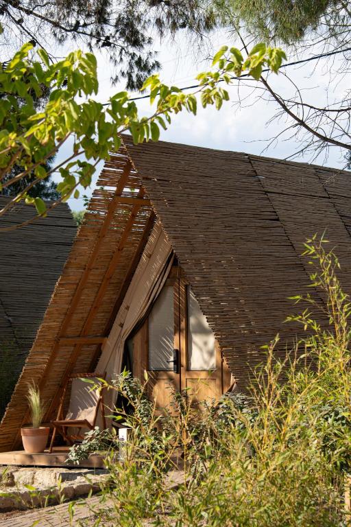 a house with a window on the side of it at Ergon Beach House Nikiti in Nikiti