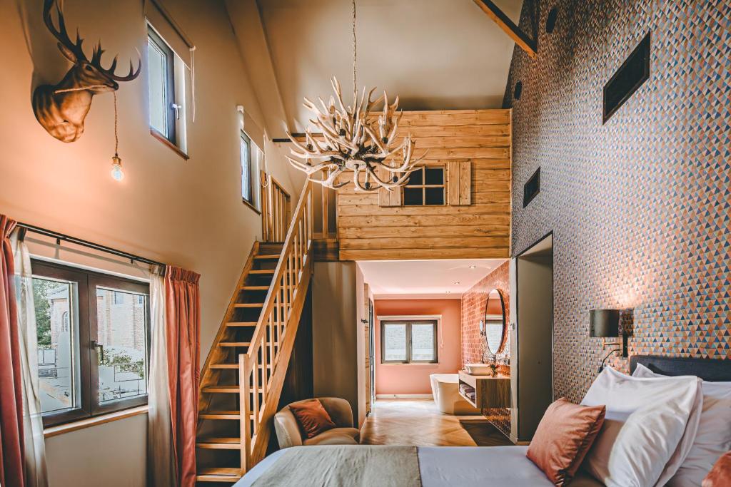 a bedroom with a bed and a spiral staircase at Hotel Centraal Baarlo in Baarlo