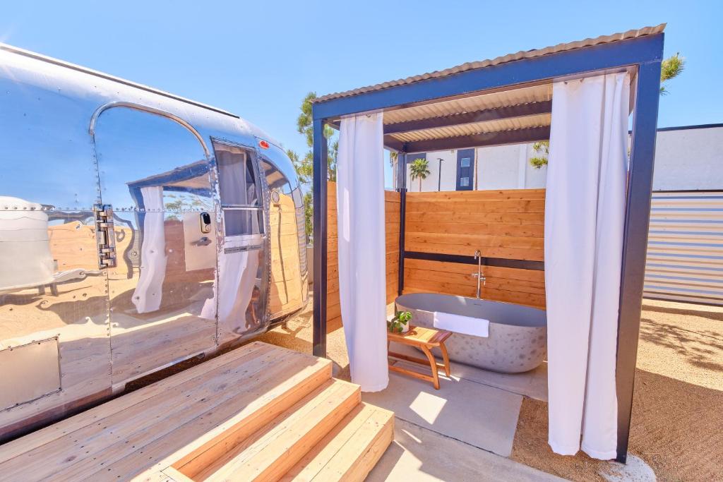 a bath tub sitting inside of a van with a porch at Acres Landing in Desert Hot Springs