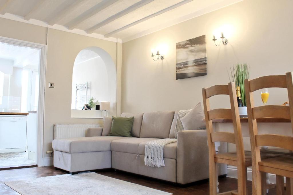 a living room with a couch and a table at Cosy Cottage in Mersea - Walking distance to beach and town in West Mersea