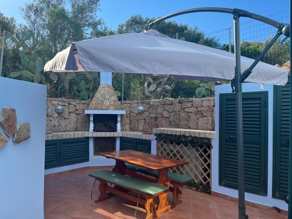 a picnic table and an umbrella on a patio at Da Masciu in La Maddalena