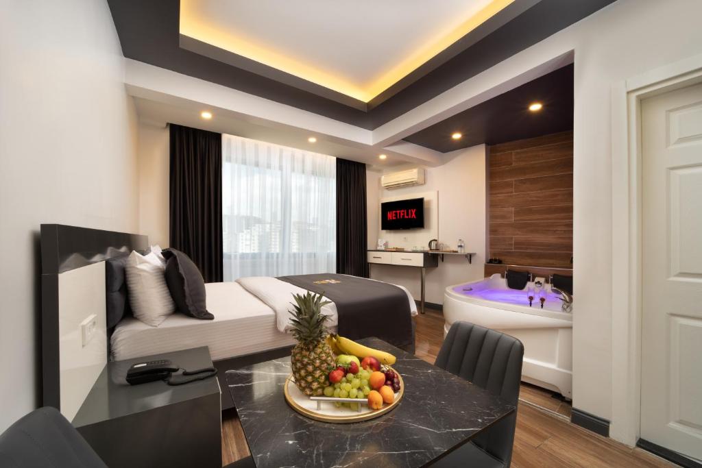 a living room with a table with a bowl of fruit at Bakırköy Zeugma Suit Otel in Istanbul