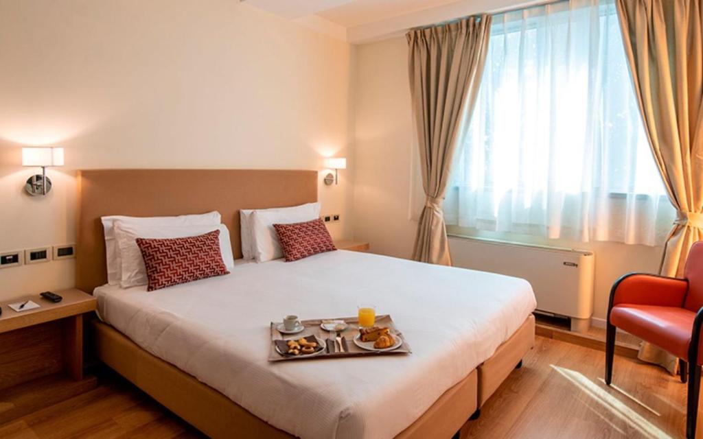 Postel nebo postele na pokoji v ubytování JR Hotels Gigli Firenze