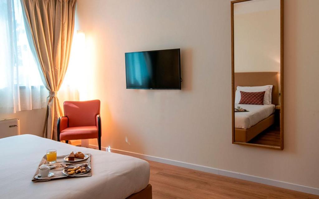 Postel nebo postele na pokoji v ubytování JR Hotels Gigli Firenze