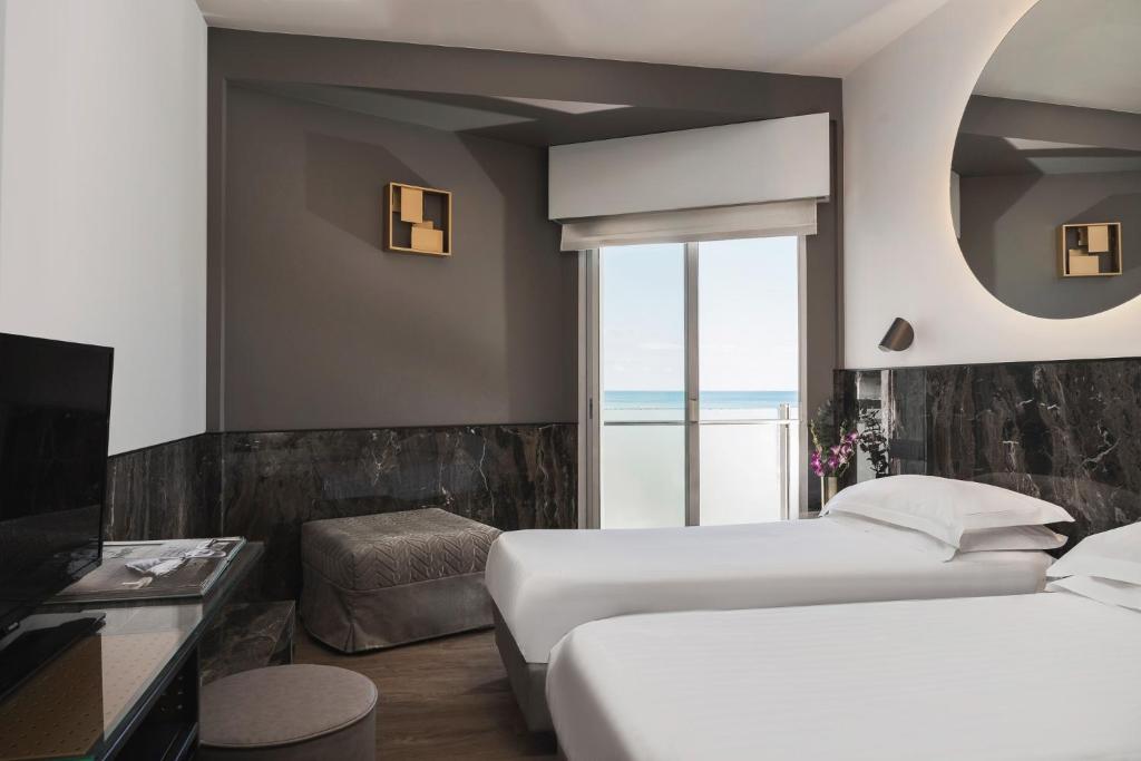Postel nebo postele na pokoji v ubytování Hotel Michelangelo