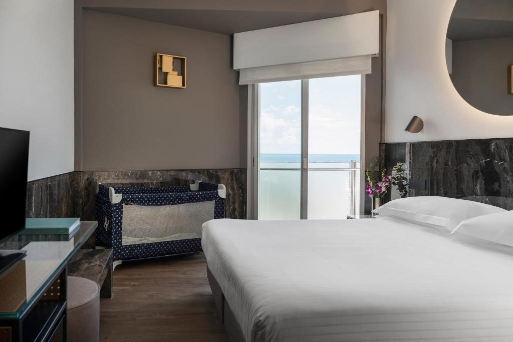Postel nebo postele na pokoji v ubytování Hotel Michelangelo