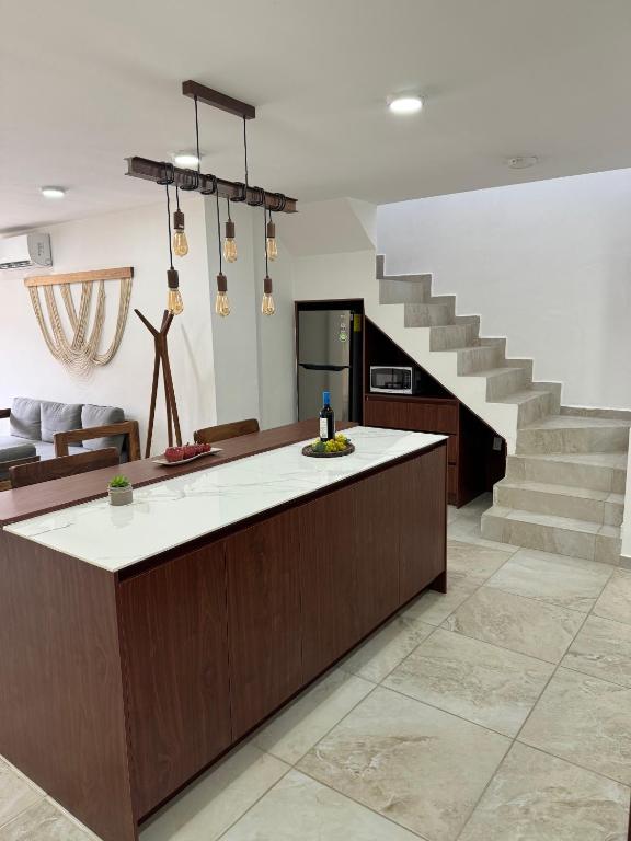a kitchen with a counter and a staircase at Nabani Condominios T2 in Santa Cruz Huatulco