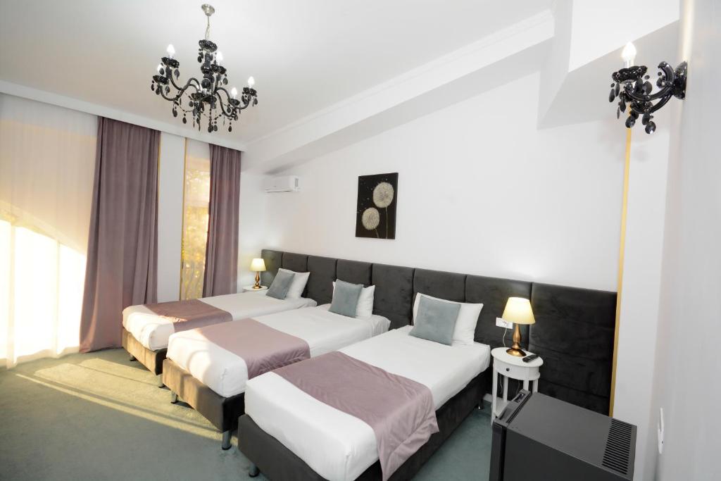 Postel nebo postele na pokoji v ubytování Hotel Andre´s