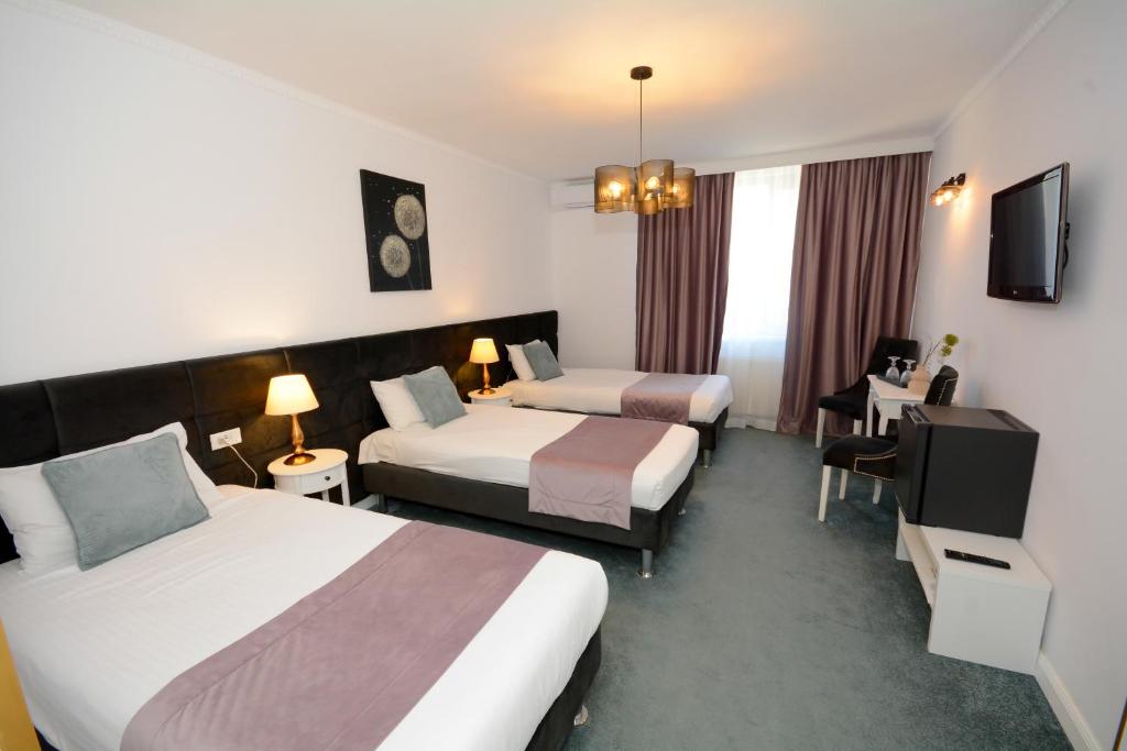Postel nebo postele na pokoji v ubytování Hotel Andre´s