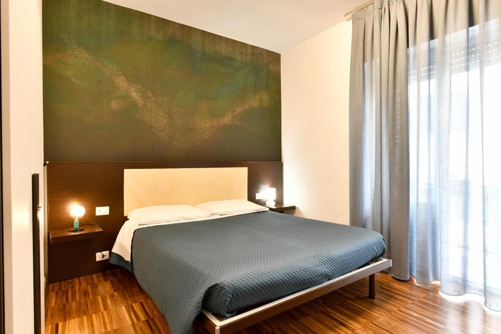 una camera da letto con un letto e un dipinto sul muro di B&B Donna Eleonora a Matera