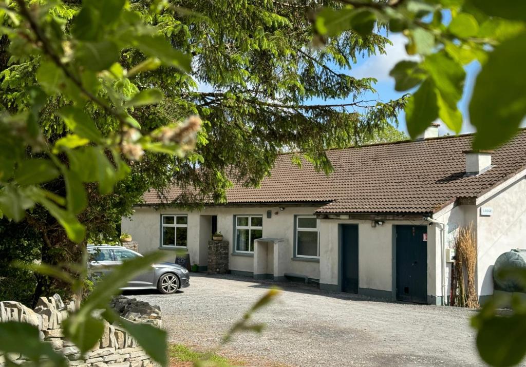 a house with a car parked in front of it at The Common Knowledge Centre in Kilfenora