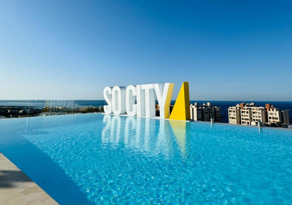 a large swimming pool on the roof of a building at SO City Hotel Adults Only in St. Julianʼs
