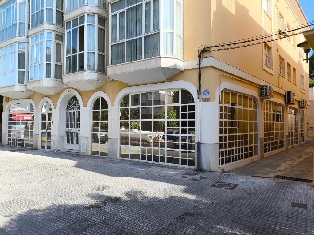 a building with gates in front of a street at Hostel Sorolla Playa in Málaga