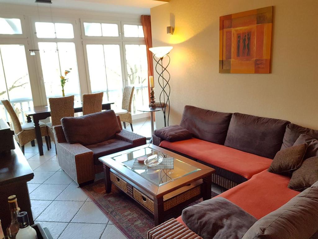 a living room with a couch and a coffee table at Dünenschloss - 02-27 in Kühlungsborn