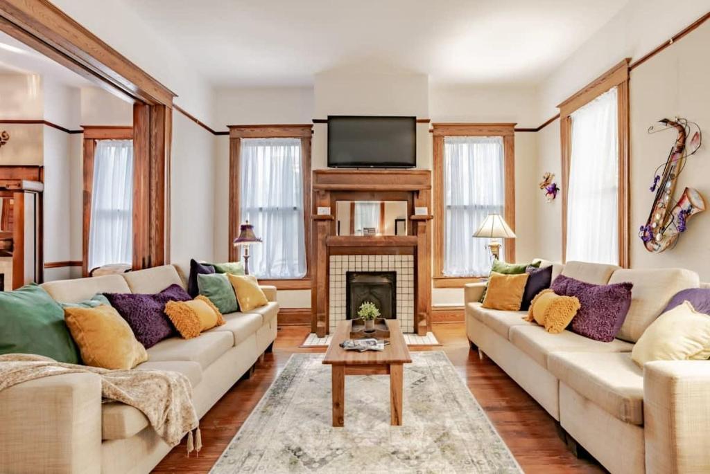 a living room with two couches and a fireplace at Heavenly on Hunter-Historic Grandeur-The Cannon in Mobile