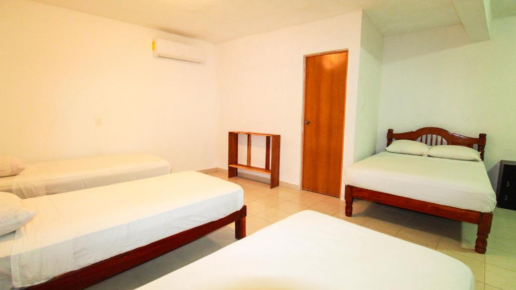 Postel nebo postele na pokoji v ubytování Hotel Vias Maya Bacalar