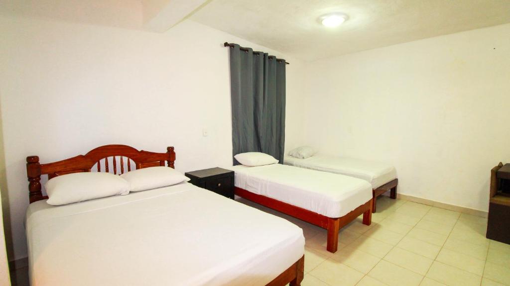 Postel nebo postele na pokoji v ubytování Hotel Vias Maya Bacalar