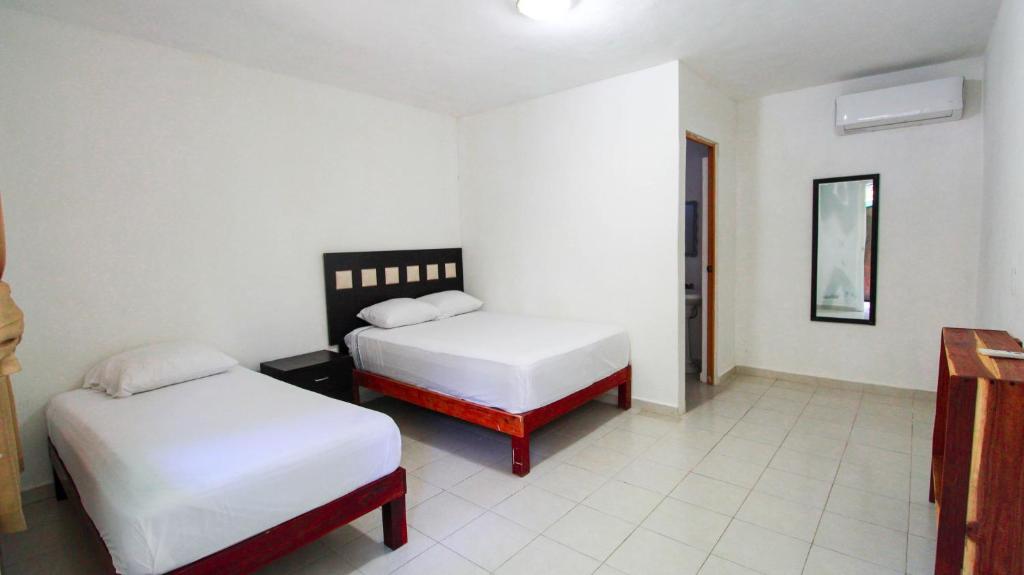 Postel nebo postele na pokoji v ubytování Hotel Vias Maya Bacalar